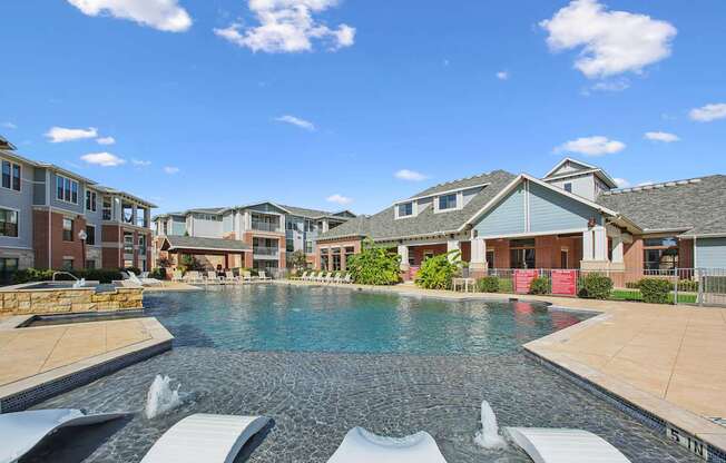 A swimming pool with a waterfall in the middle of it.