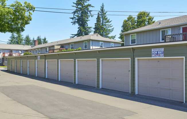 a row of garages with white garage doors in front of houses at Woodhaven, Everett, WA
