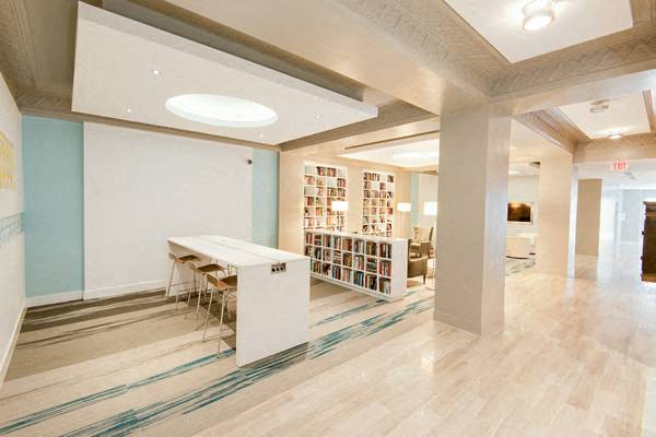 a room with a table and chairs and a bookshelf