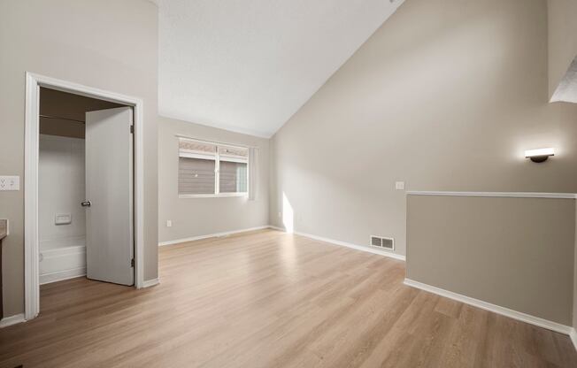 A room with a white door and a window.