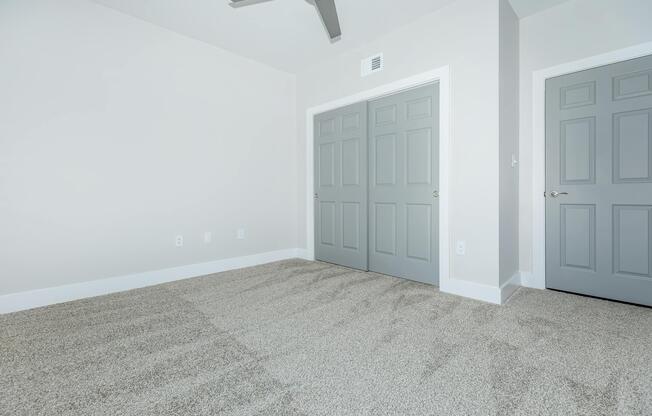 PLUSH CARPETS AND CEILING FANS IN BEDROOM