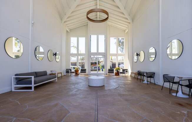 the lobby of a building with tall ceilings and large windows at Campbell West Apartments, Campbell