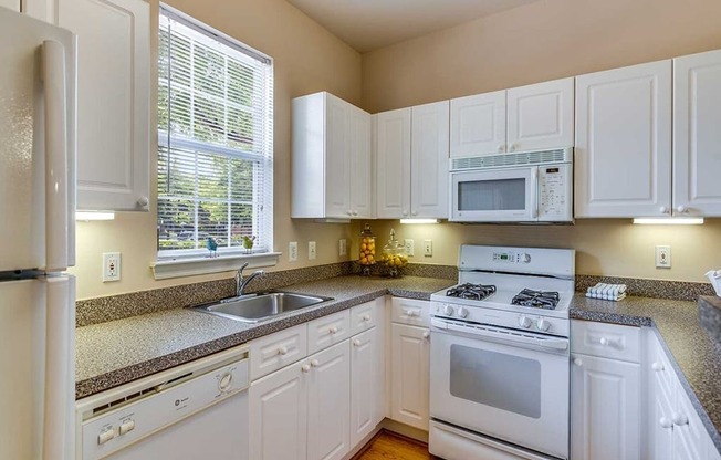 a kitchen with white appliances and white cabinets