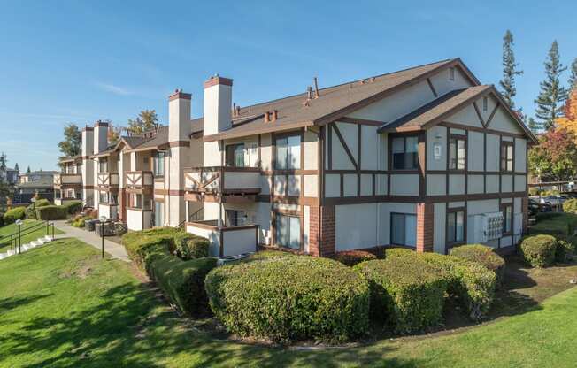 a view of a building with a yard in front of it at Rocklin Manor  Apartments, California, 95677