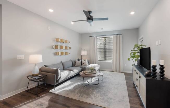 Living room with ceiling fan at AxisOne, Stuart, FL