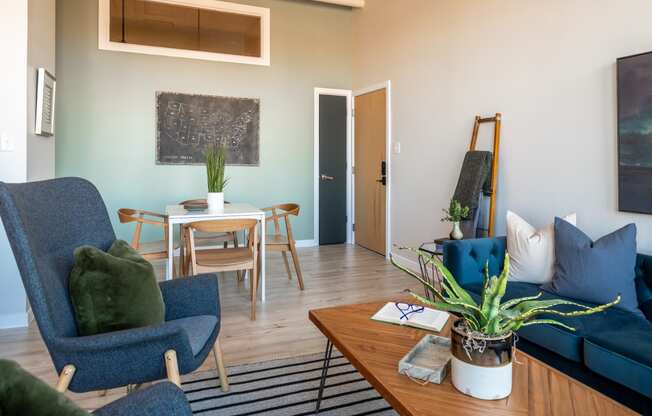 a living room with a couch chairs and a table at The 22 Apartments, St. Louis, MO