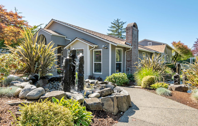 a house with a fountain in the front yard