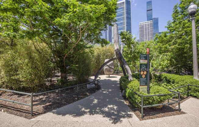 a park with trees and a sculpture in the middle at North Harbor Tower, Chicago, Illinois 60601