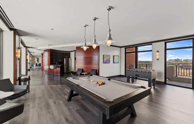 a large living room with a pool table and a bar