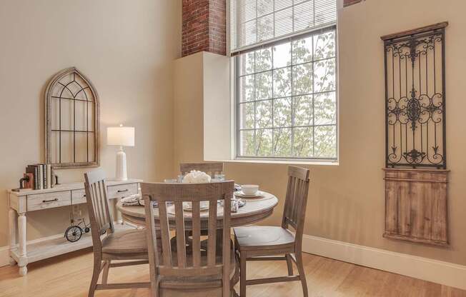a dining room with a table and chairs