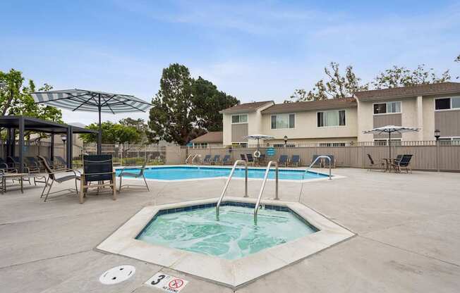 A pool with a hot tub in the middle of it.