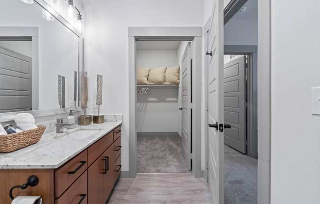 a bathroom with a sink and a door to a closet