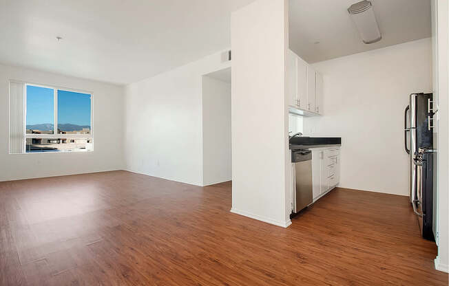 Empty room with wooden floors and white walls.at Plaza Lafayette, Los Angeles, CA 90057  