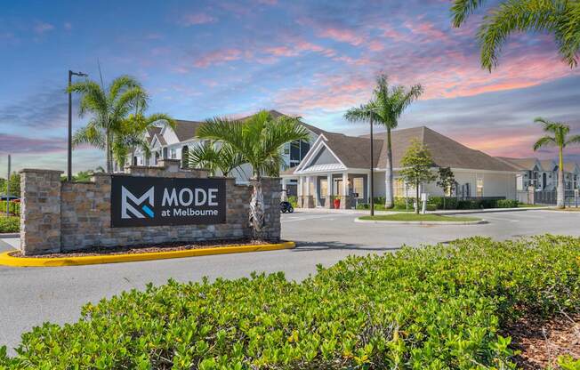 The image shows a building with the sign "MODE at Melbourne" in front of it.