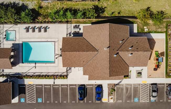 An aerial view of a parking lot with cars parked in designated spots.