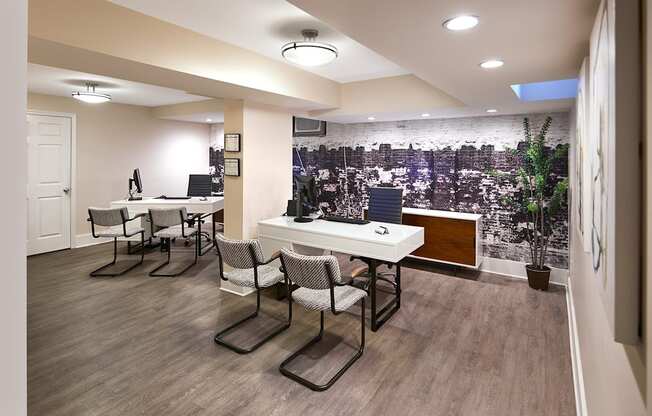 an open office with tables and chairs and a wall mural