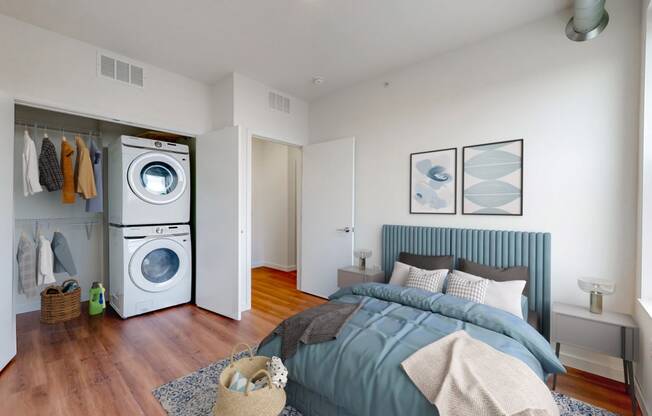 a bedroom with a bed and a washer and dryer
