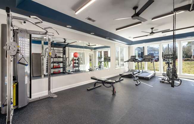 addison point interior resident gym with exercise equipment and a large window