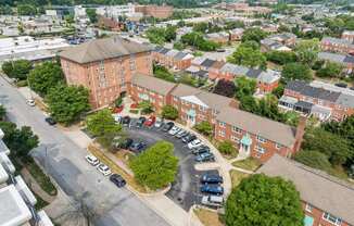 an aerial view of an apartment complex and parking lot