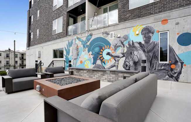 A mural of a man on a horse is painted on the side of a building.