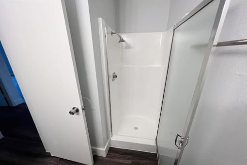 a bathroom with a shower and a sliding glass door