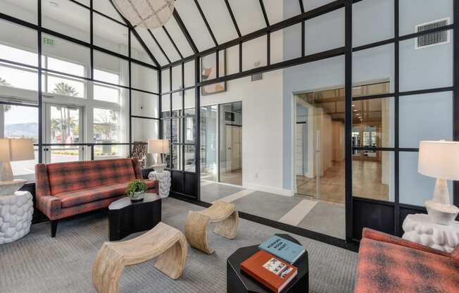 Clubhouse Entrance with Carpet, Red/Black Checker Sofa, Lamps and See Through Door to Outside at Morgan Ranch Apartments, Morgan Hill
