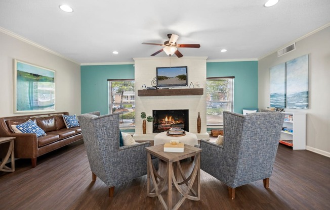 a living room with couches and chairs and a fireplace