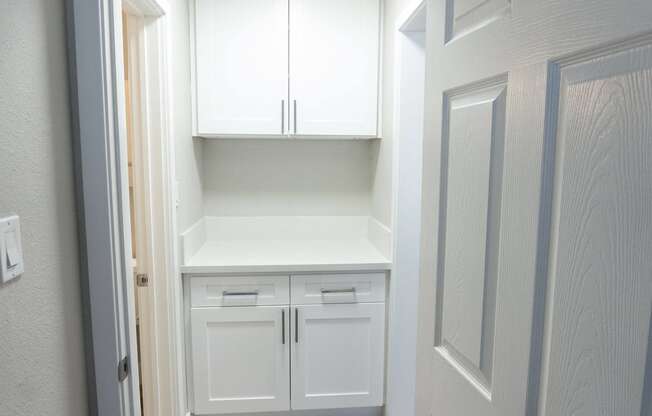 a white kitchen with white cabinets and white drawers