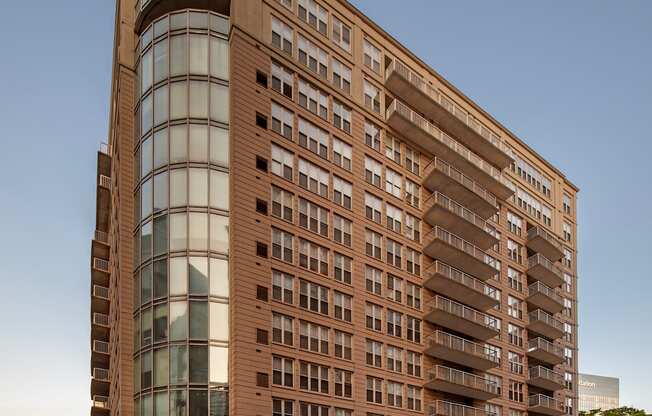 A large building with a curved glass section on the side.