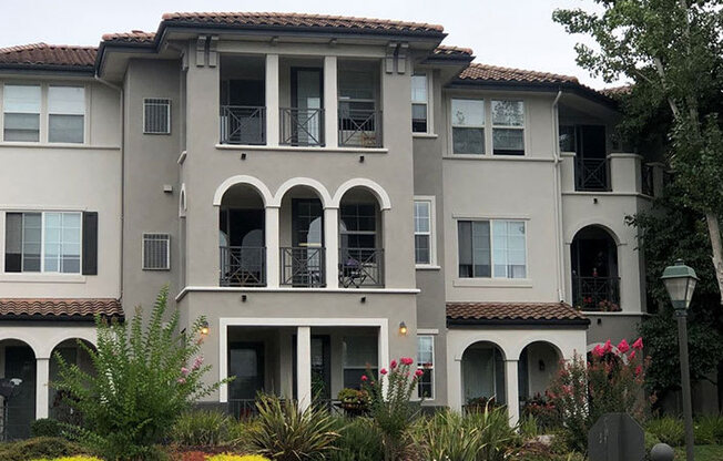 a large apartment building with a garden in front of it  at Falcon Bridge at Gale Ranch, San Ramon, California