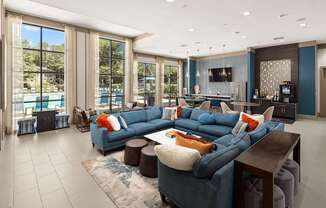 A modern living room with a large blue sectional sofa and a television.