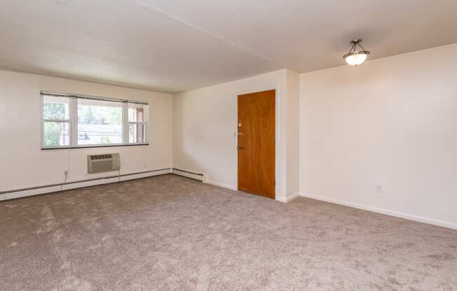 a bedroom with white walls and carpet