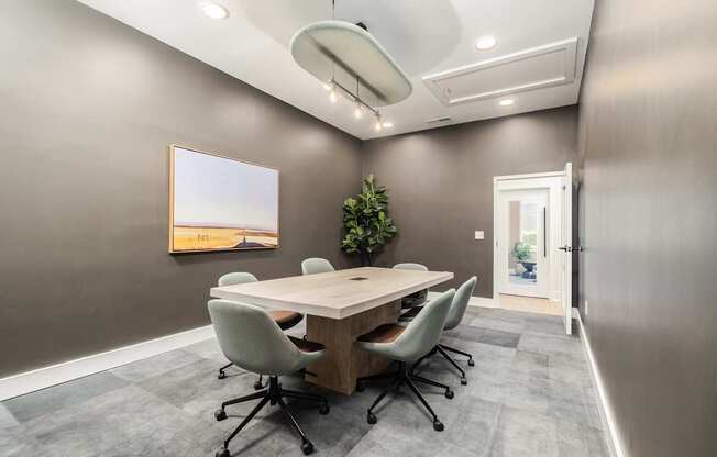 A conference room with a long table and chairs.