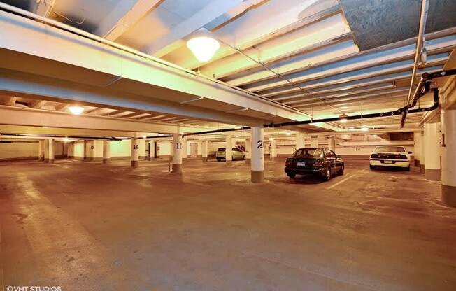 a parking garage with several cars in it