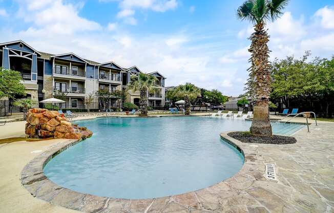 a large swimming pool with a palm tree in the middle of it