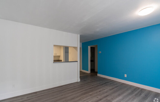 a bedroom with a blue wall and white walls