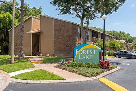 A sign that says Forest Lake in front of a building.