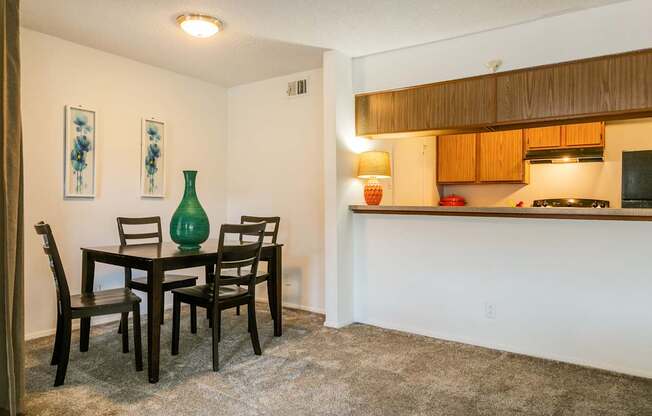 A dining room with a table and chairs.
