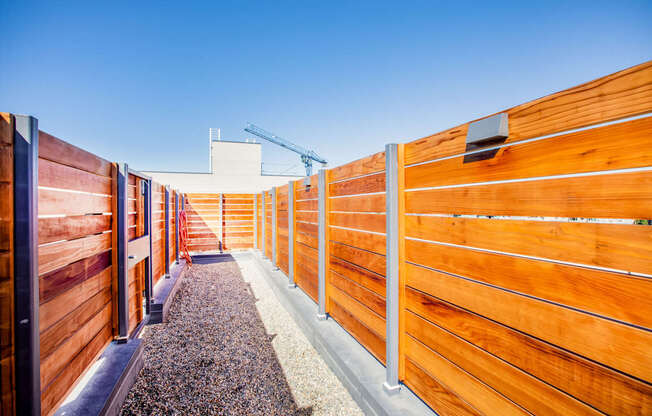 A wooden fence with a gravel path in the middle.