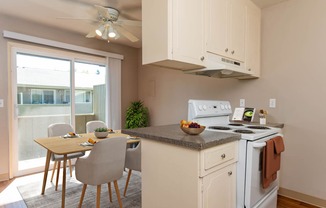 a kitchen with a table and chairs and a stove