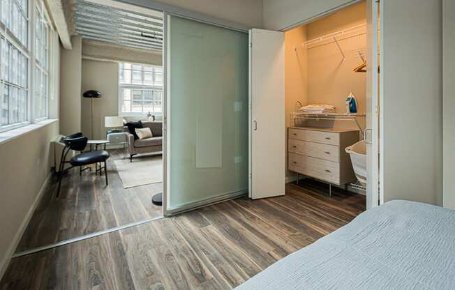 a bedroom with a bed and a bathroom with a sliding glass door