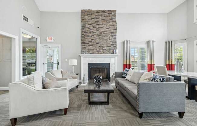 A living room with a fireplace and two couches.