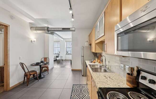 A kitchen with a stove top oven and a microwave.