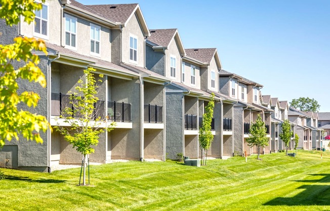 back exterior of townhomes with lawn at Prairie Pines Townhomes, Kansas
