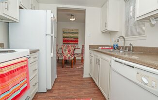 A kitchen with a white refrigerator and a white oven at Laurel Parc apartments in Shreveport, LA.