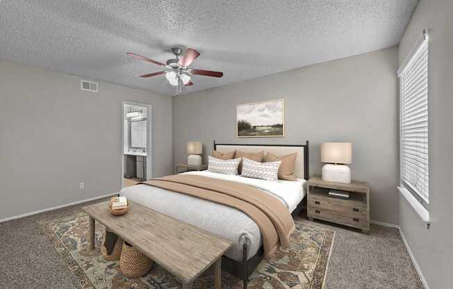 A bedroom with a bed, nightstand, and a ceiling fan.