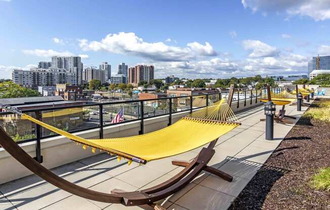 Yellow hammock on pool deck with views of skyline
