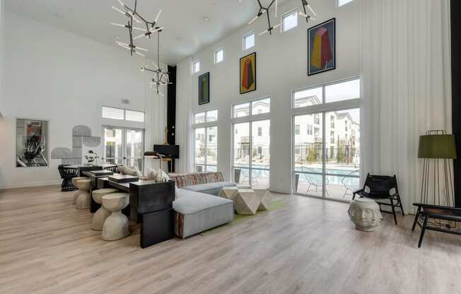 Community Clubhouse with round white table, black chairs, Hardwood Inspired Floor at Morgan Ranch Apartments, Morgan Hill, 95037