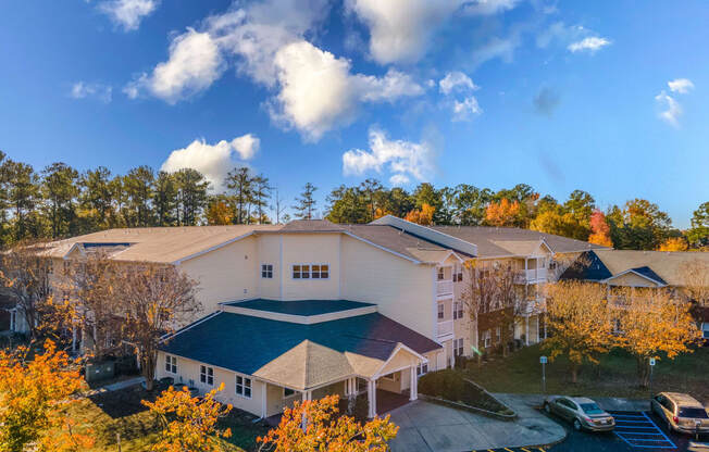 an aerial view of a large white building with a blue roof