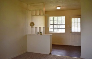 an empty room with a door and a window